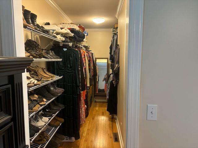  - walk in closet featuring light wood finished floors