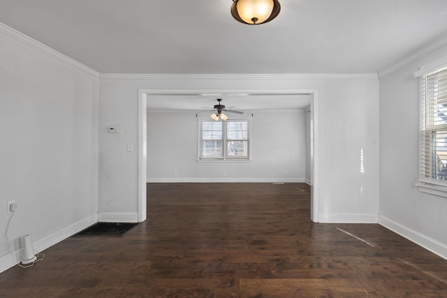 empty room featuring crown molding, dark wood-type flooring, and ceiling fan