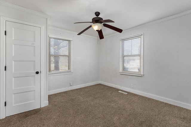 carpeted spare room with crown molding and ceiling fan