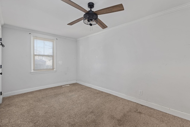 carpeted spare room with ornamental molding and ceiling fan