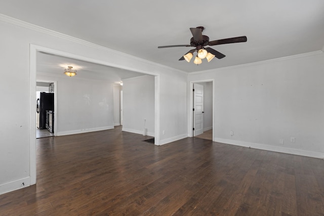 spare room with ornamental molding, dark wood-type flooring, and ceiling fan