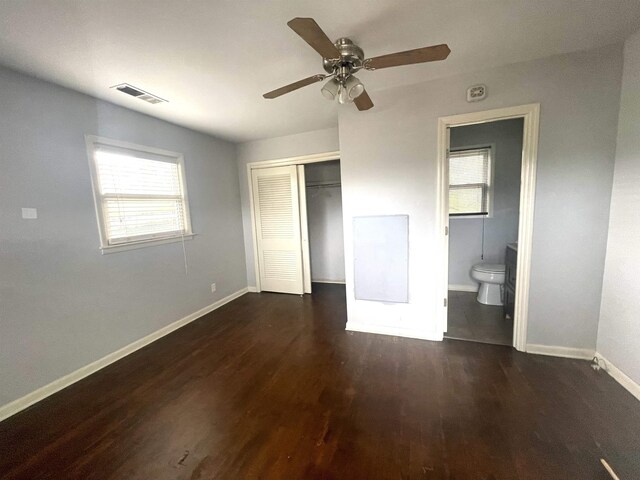 unfurnished bedroom with dark hardwood / wood-style flooring, ensuite bathroom, a closet, and ceiling fan