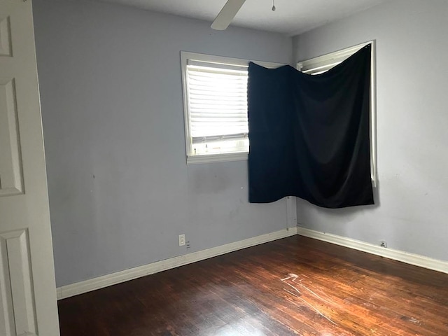 empty room featuring dark hardwood / wood-style floors and ceiling fan