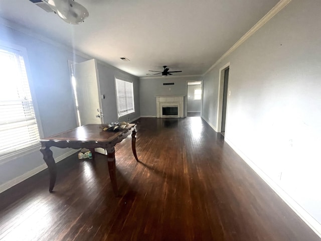 living room with ceiling fan, dark wood-type flooring, a healthy amount of sunlight, and ornamental molding