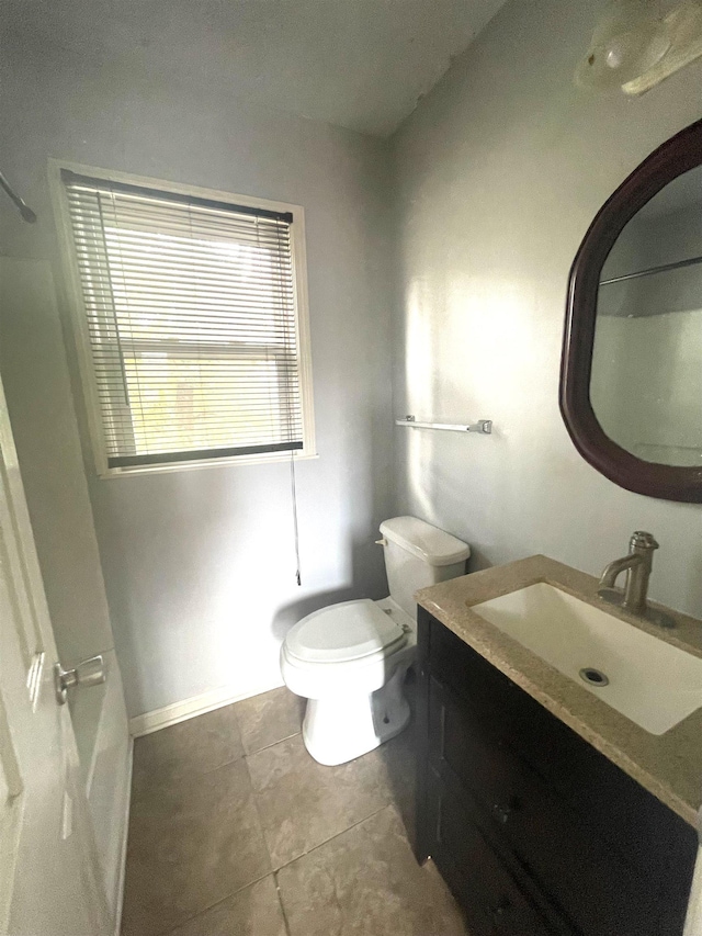 bathroom featuring tile patterned flooring, vanity, and toilet