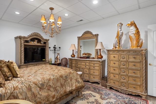 bedroom featuring a paneled ceiling and a notable chandelier