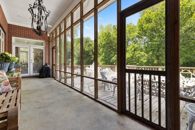 unfurnished sunroom featuring french doors and a notable chandelier