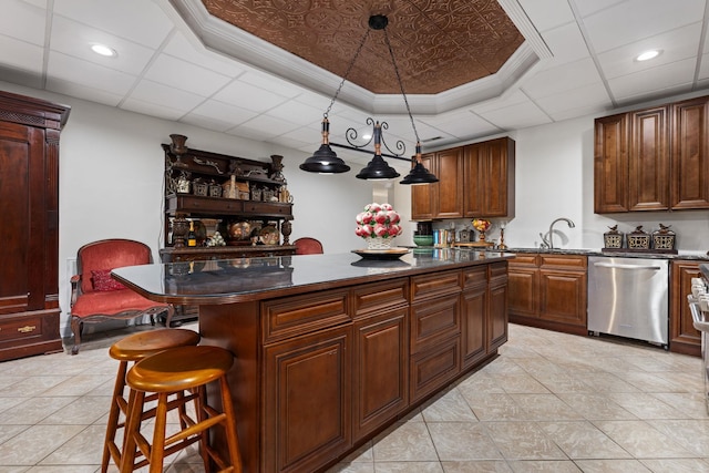 kitchen with dishwasher, a center island, a kitchen breakfast bar, and decorative light fixtures