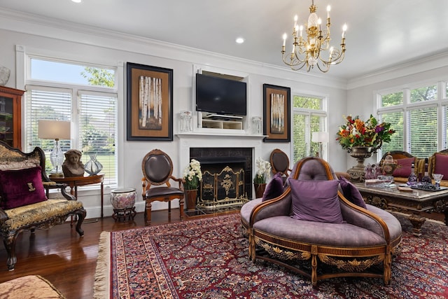 living room featuring dark hardwood / wood-style floors, an inviting chandelier, and crown molding