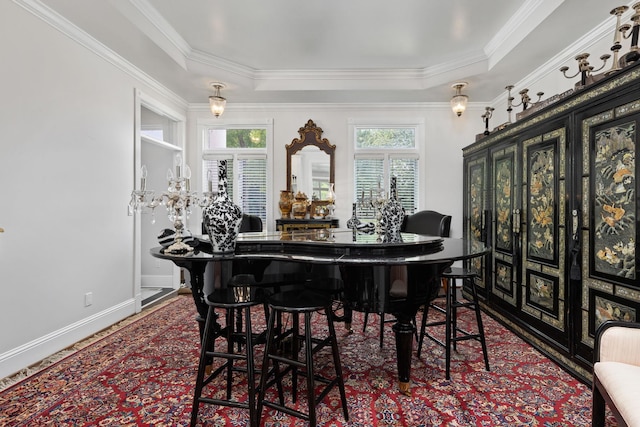 dining area with crown molding and a tray ceiling