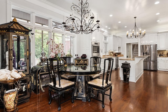 dining area with dark hardwood / wood-style floors, an inviting chandelier, crown molding, and sink