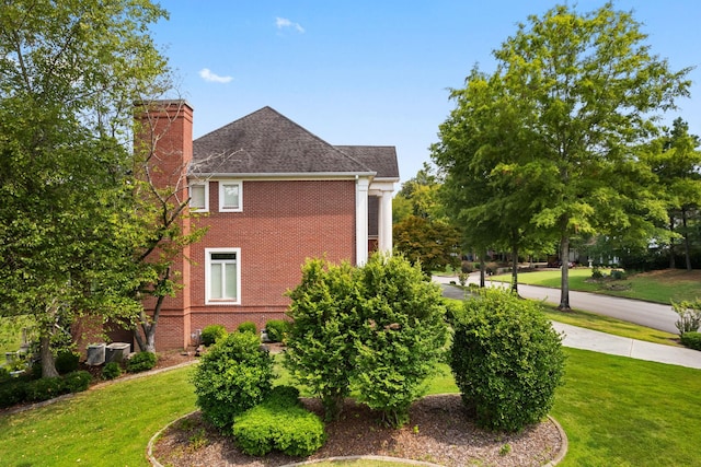 view of home's exterior featuring a lawn and cooling unit