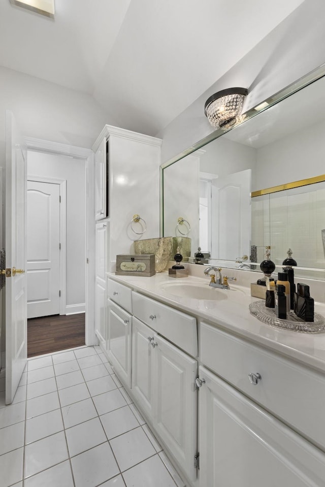 bathroom featuring vanity, tile patterned floors, and a shower with shower door