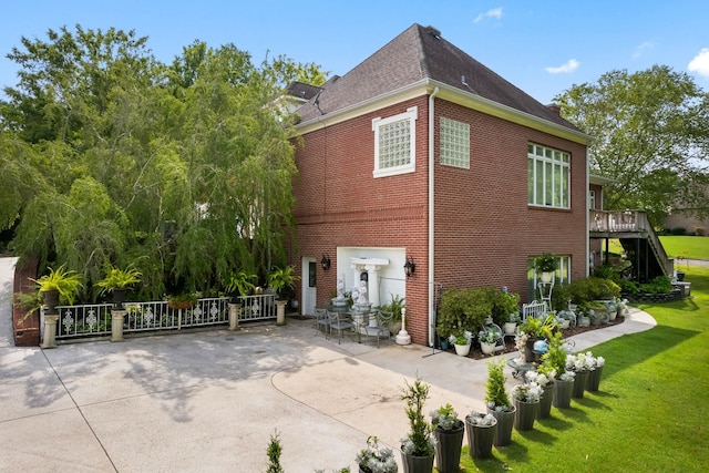 back of property with a patio area and a lawn