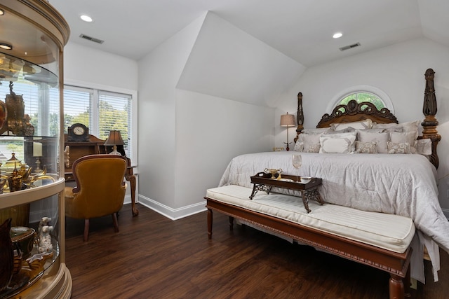 bedroom with dark wood-type flooring and lofted ceiling