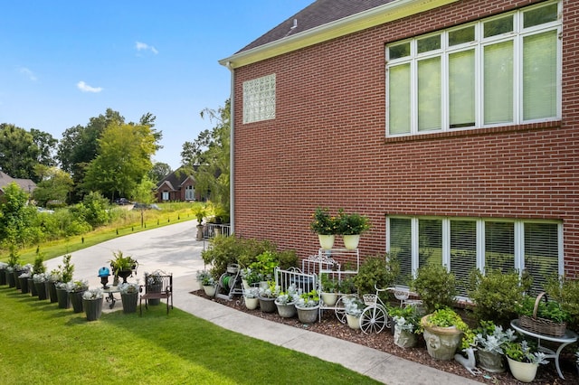 view of side of property with a lawn