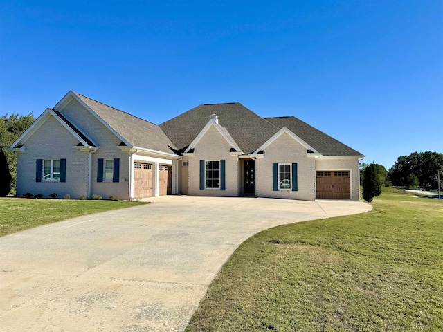 view of front of home with a front lawn and a garage