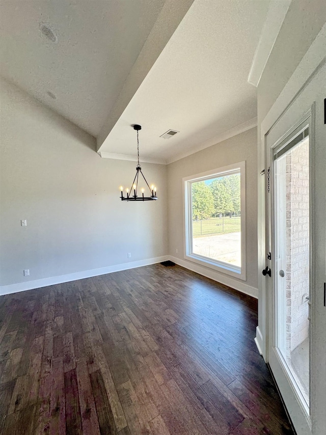 unfurnished dining area featuring an inviting chandelier, dark wood-type flooring, and crown molding