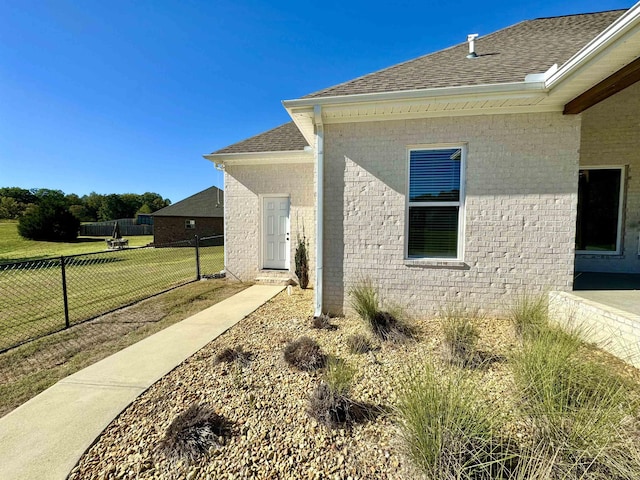 view of side of home with a yard