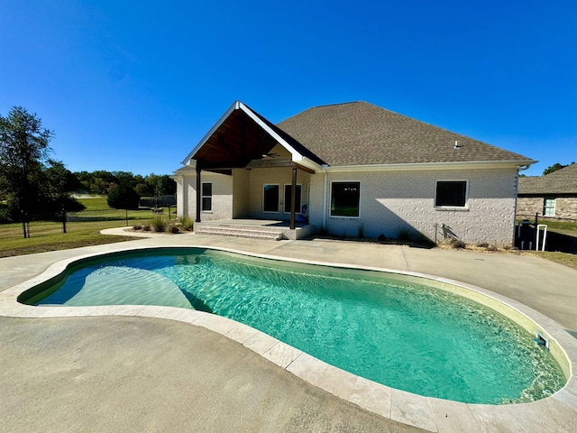 view of swimming pool with ceiling fan and a patio area