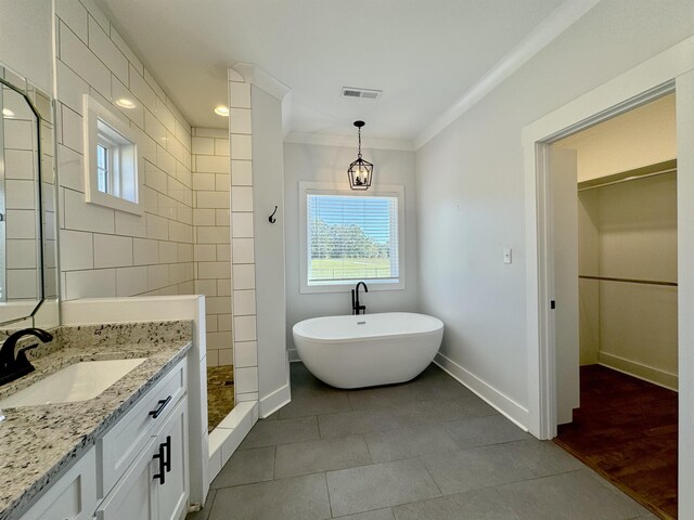 bathroom with vanity, tile patterned floors, separate shower and tub, ornamental molding, and a chandelier