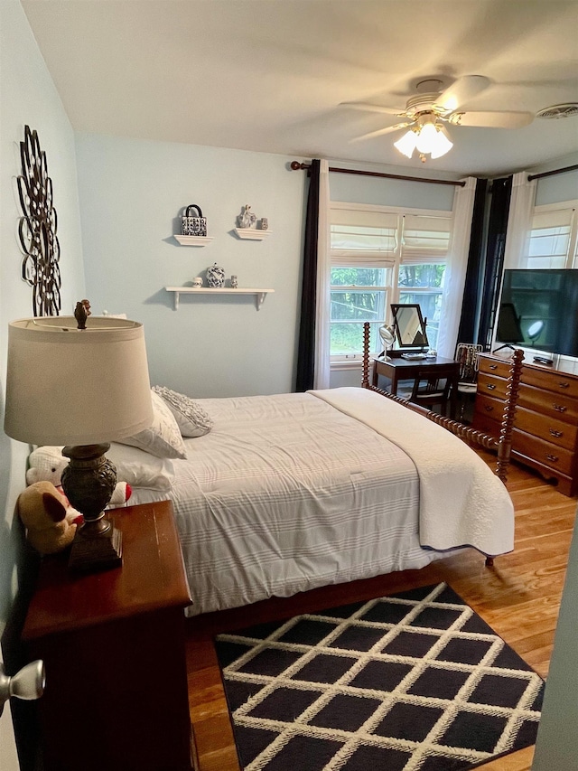bedroom with wood finished floors and a ceiling fan