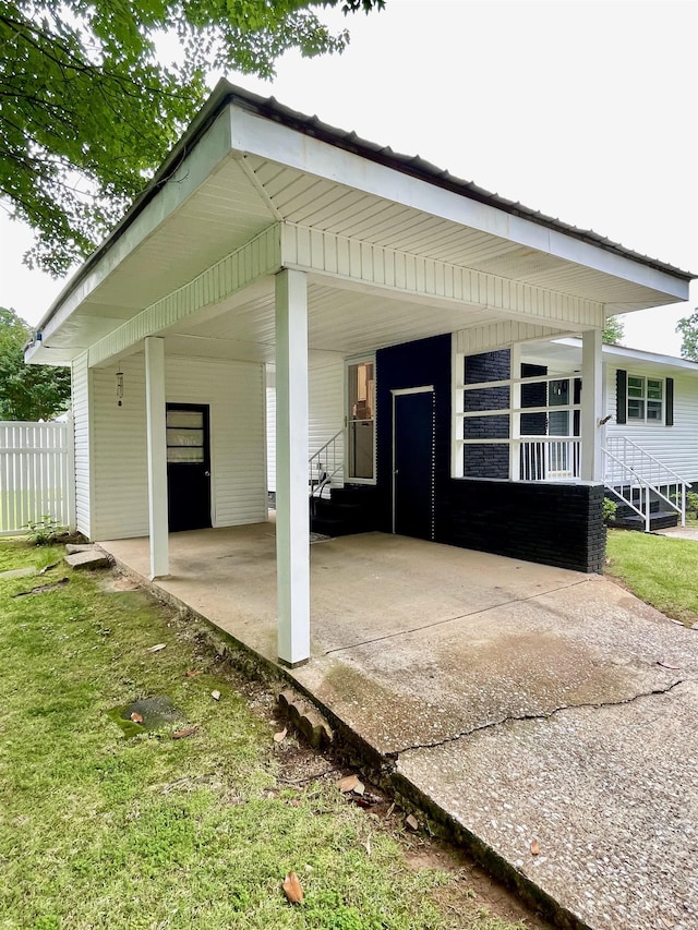 view of patio / terrace featuring a carport and driveway