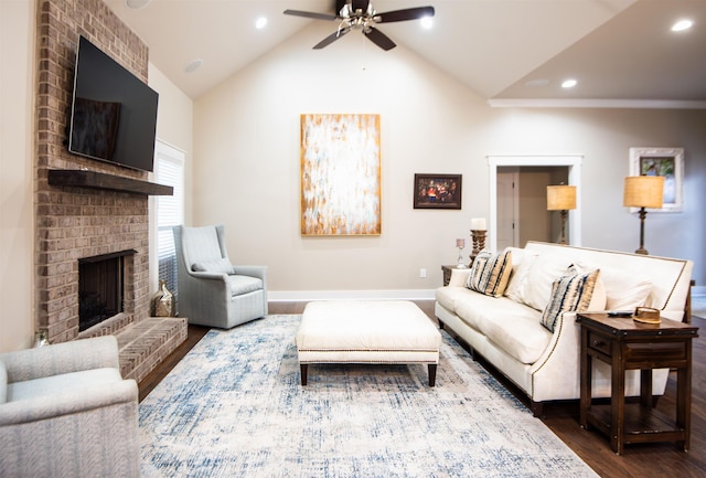 living room with ceiling fan, high vaulted ceiling, hardwood / wood-style floors, and a brick fireplace