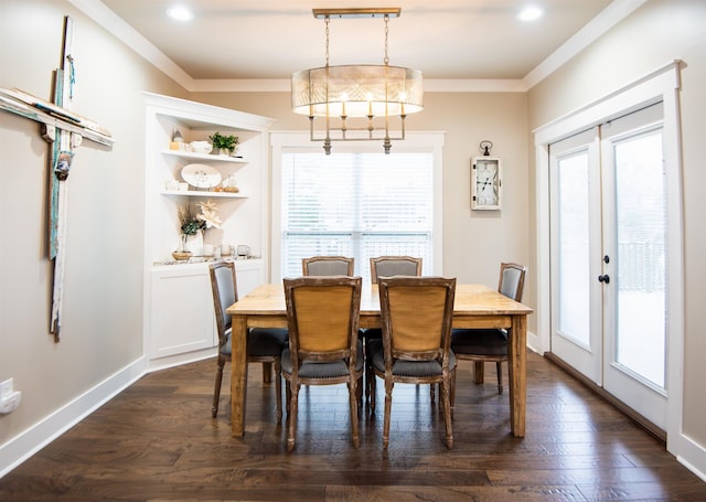 dining space with crown molding, dark hardwood / wood-style floors, and french doors