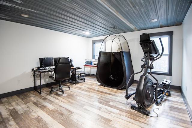 office with a healthy amount of sunlight, wood ceiling, and light wood-type flooring