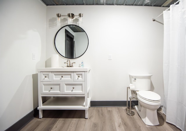 bathroom with hardwood / wood-style flooring, vanity, and toilet