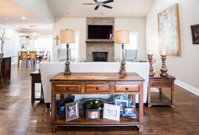 living room featuring ceiling fan, lofted ceiling, dark hardwood / wood-style flooring, and a brick fireplace