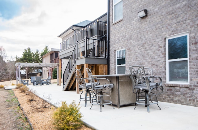 exterior space with a bar, a pergola, and a patio area