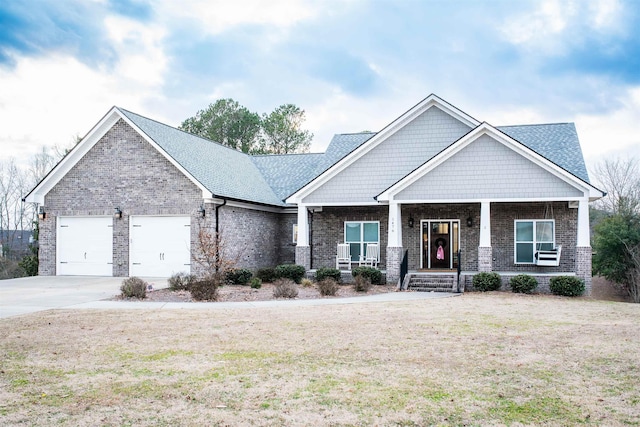 craftsman-style house featuring a porch, a garage, and a front lawn