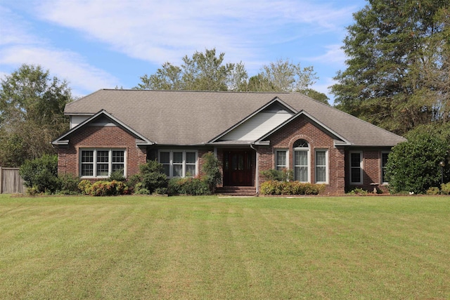 ranch-style home featuring a front lawn