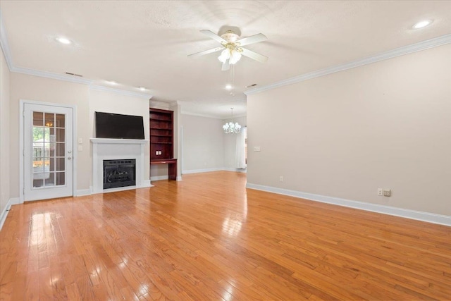 unfurnished living room featuring a ceiling fan, a fireplace, a chandelier, light wood finished floors, and baseboards