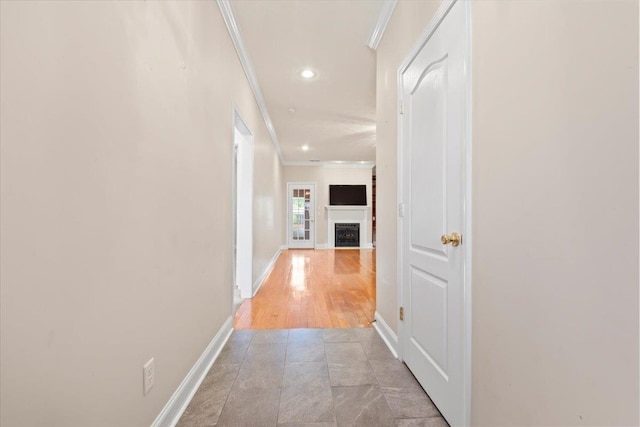 hallway with crown molding, baseboards, and recessed lighting