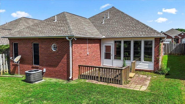 rear view of house featuring central AC, roof with shingles, brick siding, and a deck