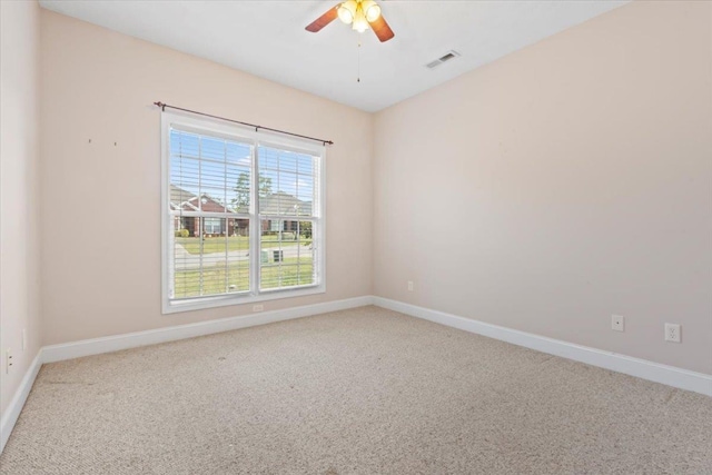 spare room with carpet, baseboards, and a ceiling fan