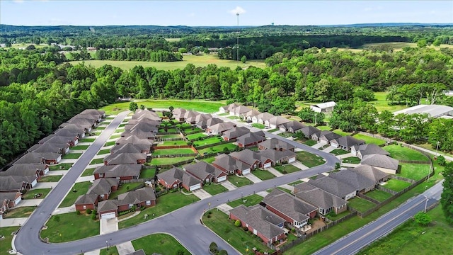 view of property location featuring a heavily wooded area and nearby suburban area