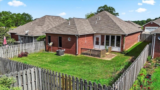 rear view of house with a sunroom, brick siding, a shingled roof, and central air condition unit