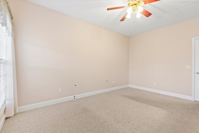 unfurnished room featuring light colored carpet, baseboards, and ceiling fan