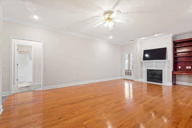 unfurnished living room with ceiling fan, light wood-type flooring, a fireplace, ornamental molding, and recessed lighting