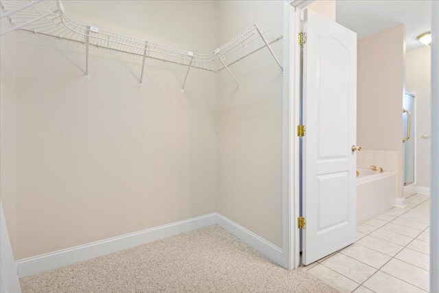 spacious closet with light tile patterned flooring