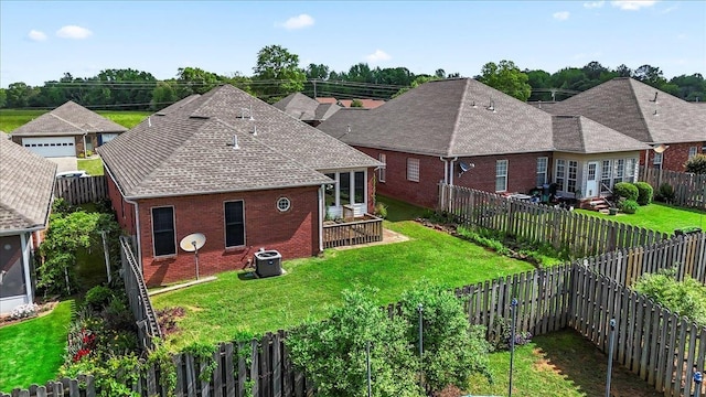 back of house with brick siding, central air condition unit, and a shingled roof