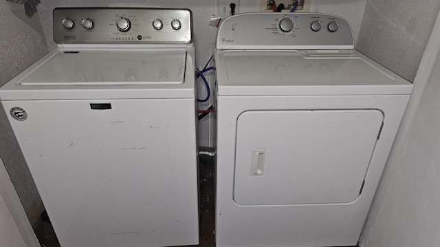 clothes washing area featuring washer and clothes dryer