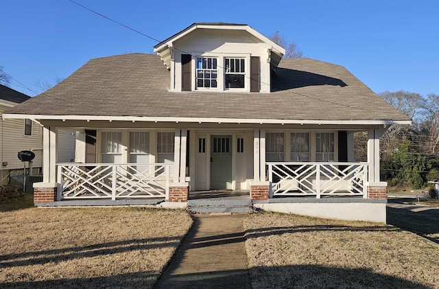 view of front of home with a front lawn and a porch