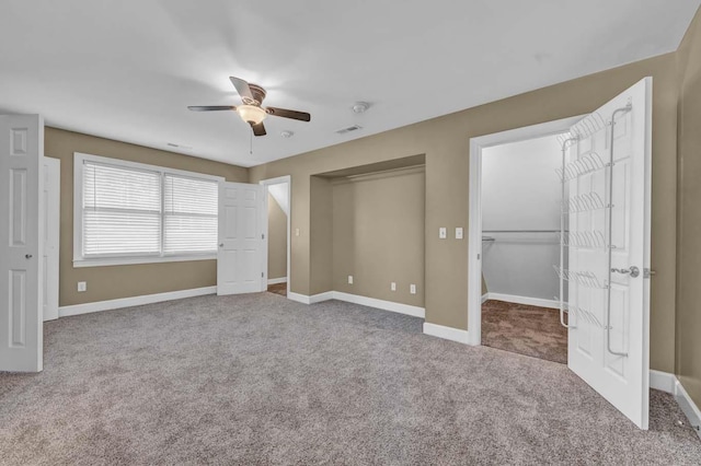 unfurnished bedroom with ceiling fan and carpet floors