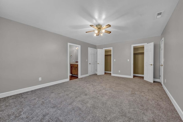 unfurnished bedroom with carpet floors, ensuite bathroom, and ceiling fan