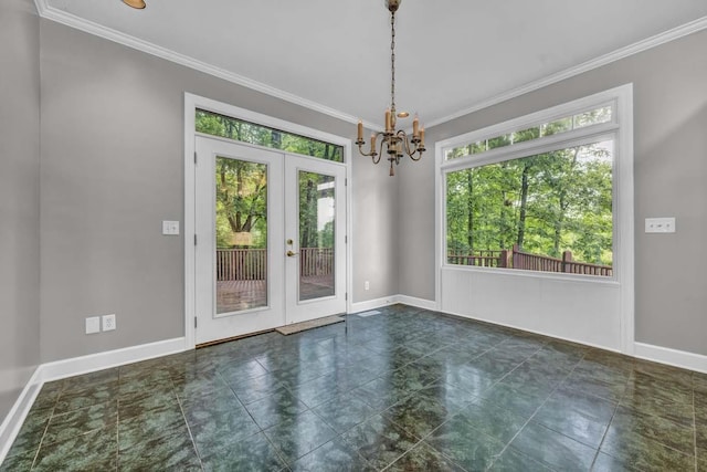 unfurnished room featuring crown molding, french doors, and a chandelier